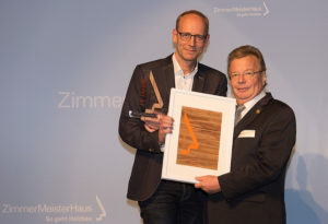 Präsident Robert Bergmüller gratuliert mit Urkunde und Award Herrn Carsten Vierck von Vierck Schwedenhäuser.